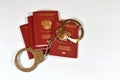 Russian passport and handcuffs on white background. prohibition of Russian citizens on entry and exit. passport lock