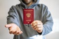 Russian passport in the hands of a man. Prohibition of Schengen visas for Russian tourists to travel to the European