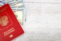 Russian passport with hundred dollar bills on white wooden desk Royalty Free Stock Photo