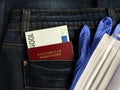Russian passport and money are in the jeans pocket. Blue gloves and a mask are next to it Royalty Free Stock Photo