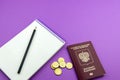 Russian passport and several coins. Notepad for entries on an purple background Royalty Free Stock Photo