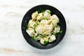 Russian pelmeni meat Dumplings with greens in a black plate. Russian traditional cuisine. Royalty Free Stock Photo