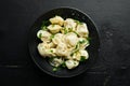 Russian pelmeni meat Dumplings with greens in a black plate. Russian traditional cuisine. Royalty Free Stock Photo