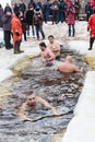 Russian people are dipped into an ice hole on the day of the Epiphany, St. Petersburg