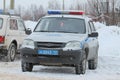 Russian police car in winter stands on the background of a snowdrift