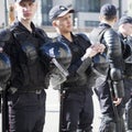 Russian police in protective gear opposes the demonstrators during opposition protests