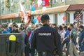 Russian policeman in uniform with a badge on the street at a rally of protest,