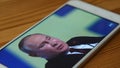 Russian President Vladimir Putin's speech at a forum in St. Petersburg. Watching the news on your smartphone