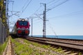 Russian Railways train moving by rail-on a summer day, people go on vacation