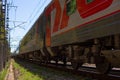 Russian Railways train moving by rail-on a summer day, people go on vacation