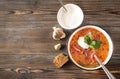 Russian red soup , ukrainian borscht with parsley and  sour cream  , garlic, bread, spoon, top view, soup Royalty Free Stock Photo