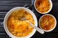 Russian Romanoff casserole made from potatoes, sour cream and cheddar cheese close-up in a pan. horizontal top view