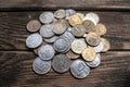 Bunch of coins on the aged rough wooden windowsill.