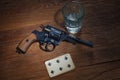 Russian roulette - Six of Spades plaing card, glass of vodka and revolver with one cartridge in drum Royalty Free Stock Photo