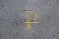 The Russian ruble sign made of yellow metal is placed on the asphalt. Russian money, finance infographic design element