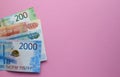 Russian rubles on a pink background. Thousand notes and various coins. Copy space