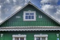 Russian rural landscape in summer, village houses on river bank in greenery