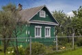 Russian rural landscape in summer, village houses on river bank in greenery