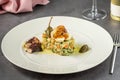 Russian salad with aioli sauce, shrimp, octopus and capers on a white porcelain plate Royalty Free Stock Photo