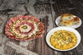 Russian Salad with Appetizer Savory Dish Meze and Spinach Cheese Pie Zeljanica on Old Cracked Wooden Garden Table Royalty Free Stock Photo