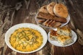 Bowl Of Russian Salad With Plates Of Baguette And Pitta Bread And Spinach Cheese Pie Set On Old Weathered Cracked Garden Table Royalty Free Stock Photo