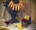 Russian samovar, tea with lemon in faceted glasses with cup holders and bublik. Tinted photo in vintage style Royalty Free Stock Photo