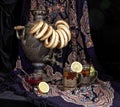 Russian samovar, tea with lemon in faceted glasses with cup holders and bublik. Tinted photo in vintage style on black background