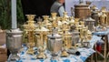 Russian samovars stand on the table for sale. Bronze samovar. Royalty Free Stock Photo