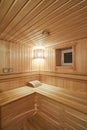 Russian sauna bathhouse with Linden Lining walls and ceiling Abash or African oak bench lanterns hygrometer thermometer Royalty Free Stock Photo