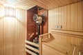 Russian sauna bathhouse with Linden Lining walls and ceiling Abash or African oak bench lanterns hygrometer thermometer Royalty Free Stock Photo