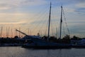 Russian schooner Nadezhda backlit at summer sunset, marina of the yacht port Hercules Royalty Free Stock Photo