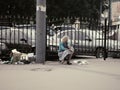 Russian seniors - poorly dressed old woman at street hawkering near garbage
