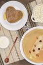 Russian Shrovetide Maslenitsa Butter Week festival meal homemade. Blini crepes pancakes with fresh cottage cheese, sour cream