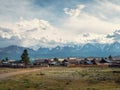 Russian siberian village with dirt road and traditional ancient wooden houses. Wooden houses in an old Siberian Kurai village.