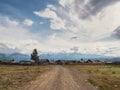 Russian siberian village with dirt road and traditional ancient wooden houses. Wooden houses in an old Siberian Kurai village.