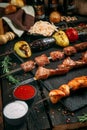 Russian snack for alcohol with potatoes, pickles and herringappetizing assorted set kebab sticks with red sauce and pickled onion Royalty Free Stock Photo