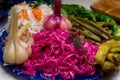 Russian snack: sauerkraut with beet and vegetables: garlic, cucumber, chili pepper on the table. Celebration.