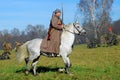 Russian soldier-reenactor rides a white horse.