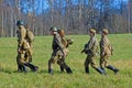 Russian soldiers-reenactors walk on green grass Royalty Free Stock Photo