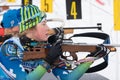 Russian sportswoman biathlete Legostaeva Anastasia rifle shooting in prone position. Biathlete in shooting range