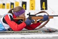 Russian sportswoman biathlete Vakhrusheva Valentina rifle shooting in prone position. Biathlete in shooting range. Junior biathlon