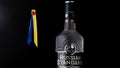 Russian Standard vodka with Ukrainian flag colors behind on black background
