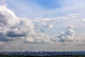 Russian summer daylight cityscape with large cumulus clouds and tiny horizon line of the panel condominium houses Royalty Free Stock Photo