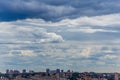 Russian summer daylight cityscape with large cumulus clouds and tiny horizon line of the panel condominium houses Royalty Free Stock Photo