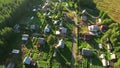 Russian summer village with wooden houses. Flying over roofs. Evergreen forests and marshes of northern Karelia, Russia