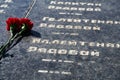 Russian text - sergeant,major, colonel,lieutenant, ranker - army ranks, flowers on the memorial to fallen soldiers, red carnations