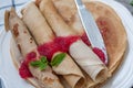 Russian thin pancakes with butter, cheese, jam, mint