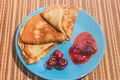 Russian traditional dish pancakes with cherries, jam and milk
