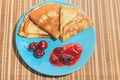 Russian traditional dish pancakes with cherries and jam