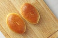 Russian traditional patties with egg and green onion lie on a wooden board. Delicious ruddy baked patties. Design with copy space Royalty Free Stock Photo